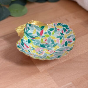 Repose bijoux original coquillage feuillage pastel vu de face sur support bois.